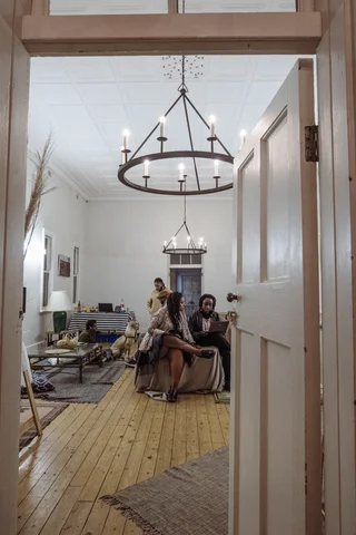 Warm shared interior with timber and plants